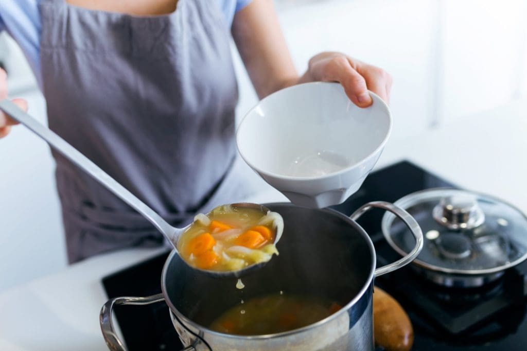 Woman dishing soup